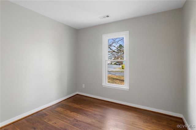 unfurnished room with dark hardwood / wood-style floors