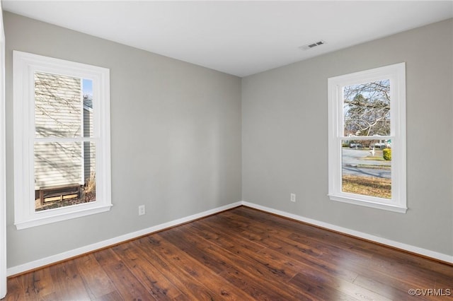 unfurnished room with dark hardwood / wood-style floors