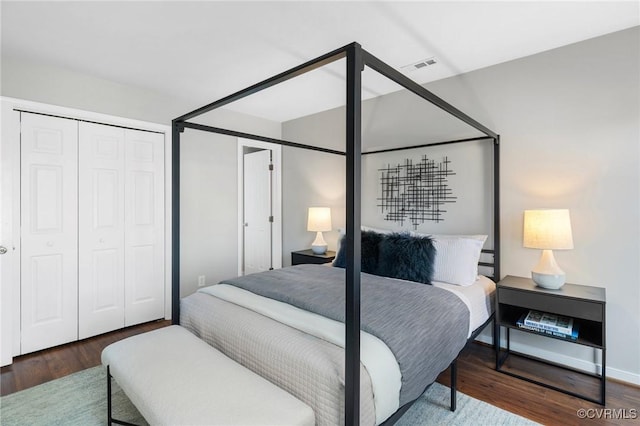 bedroom with a closet and dark hardwood / wood-style floors