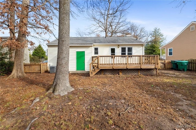 rear view of property featuring a wooden deck