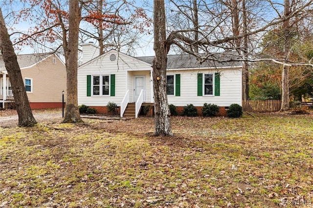 ranch-style house featuring a front lawn