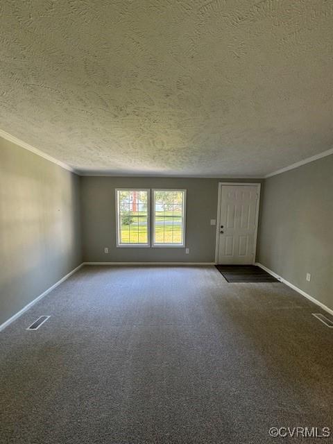 empty room with a textured ceiling and ornamental molding