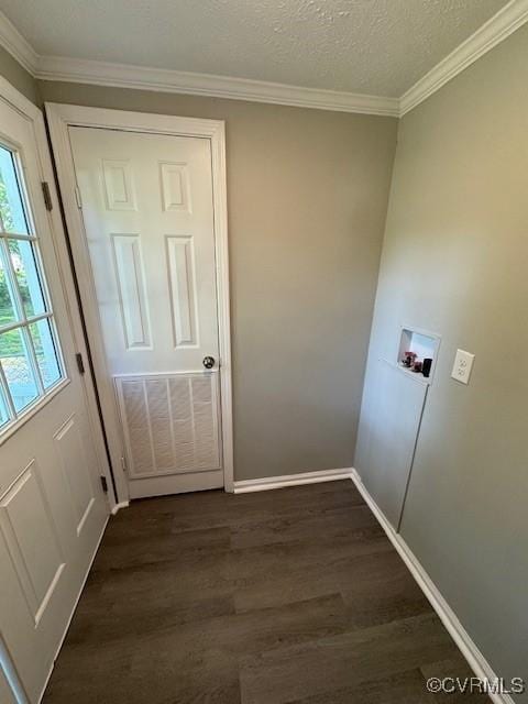 clothes washing area featuring washer hookup, dark hardwood / wood-style flooring, ornamental molding, and a textured ceiling