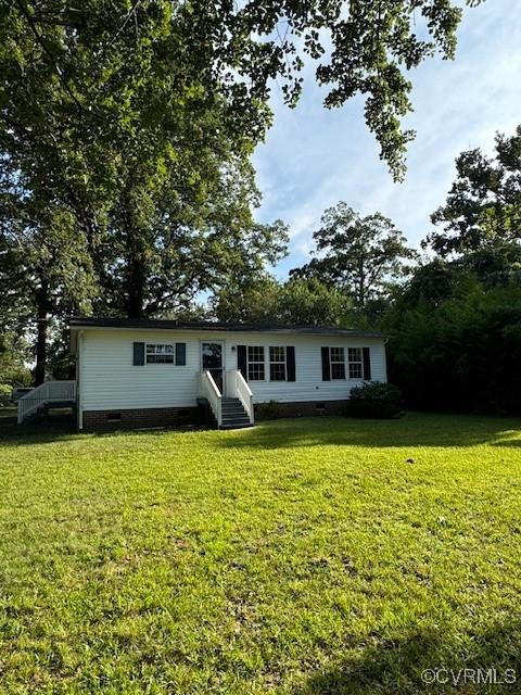 back of house with a lawn