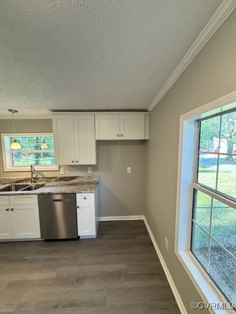 kitchen featuring stainless steel dishwasher, a textured ceiling, sink, pendant lighting, and white cabinets