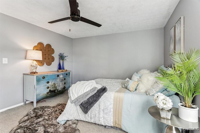 bedroom with carpet flooring, ceiling fan, and a textured ceiling