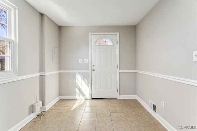 entryway with light tile patterned floors