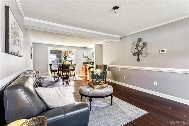 living room with wood-type flooring, a textured ceiling, and ornamental molding