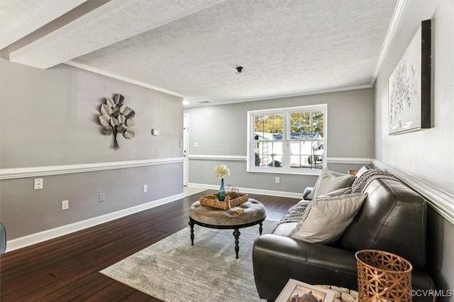 living room with dark hardwood / wood-style flooring, a textured ceiling, and ornamental molding