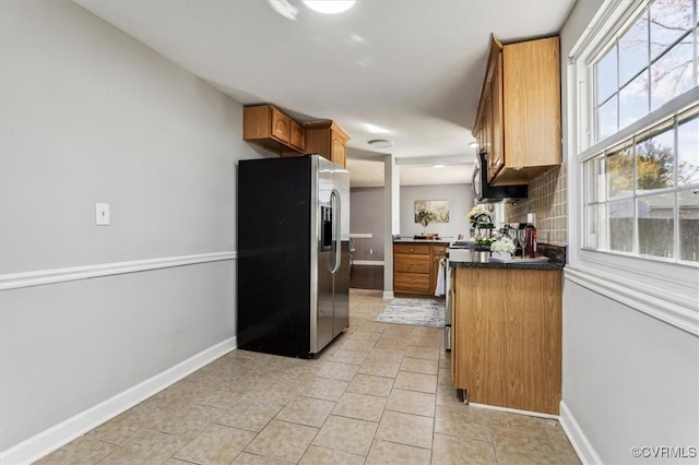 kitchen featuring backsplash, a healthy amount of sunlight, and stainless steel appliances