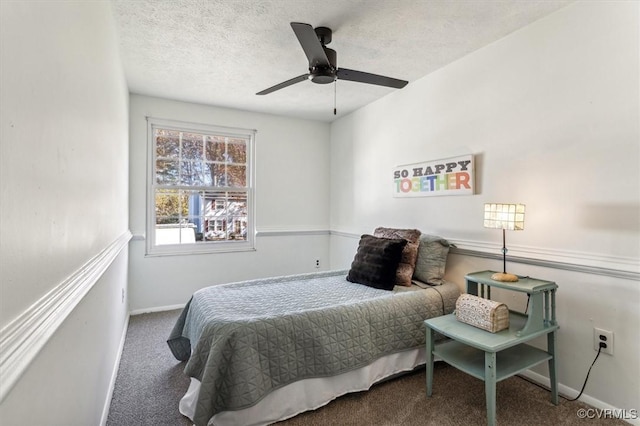 carpeted bedroom with ceiling fan and a textured ceiling