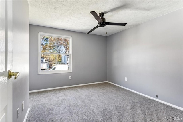 unfurnished room with ceiling fan, carpet, and a textured ceiling