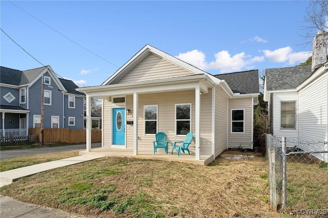 bungalow-style home featuring a front yard and a porch