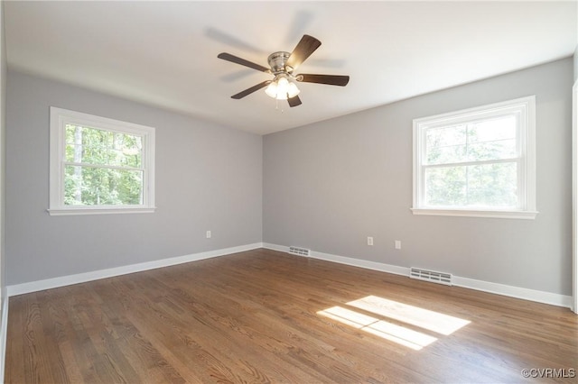 empty room with hardwood / wood-style flooring and ceiling fan