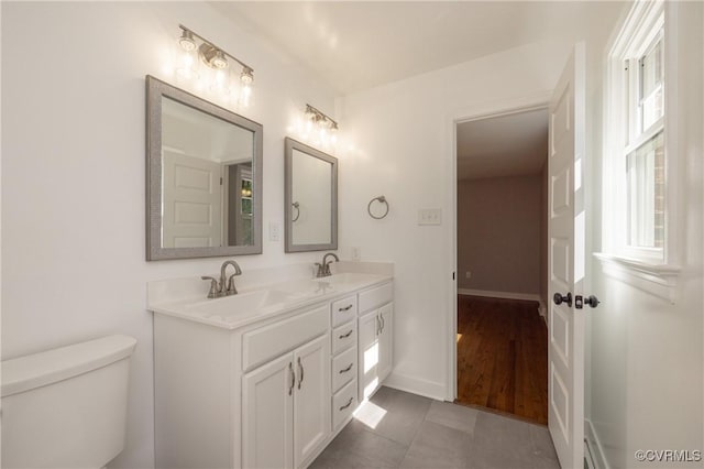 bathroom with tile patterned floors, vanity, and toilet