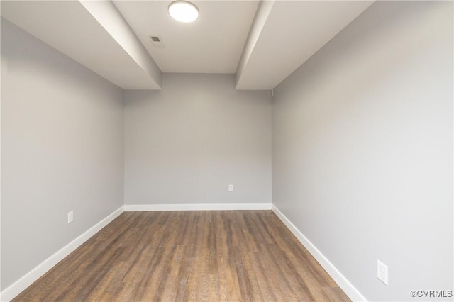 spare room with dark wood-type flooring