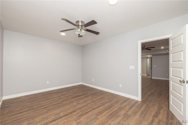 unfurnished room featuring ceiling fan and dark wood-type flooring