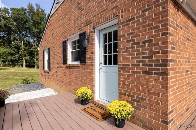 entrance to property with a lawn