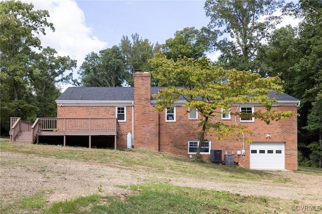 back of property with central AC unit, a garage, and a wooden deck