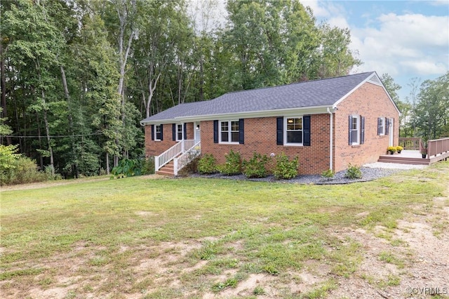 ranch-style home featuring a deck and a front lawn