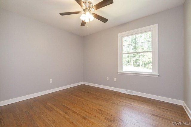 unfurnished room with dark hardwood / wood-style floors and ceiling fan