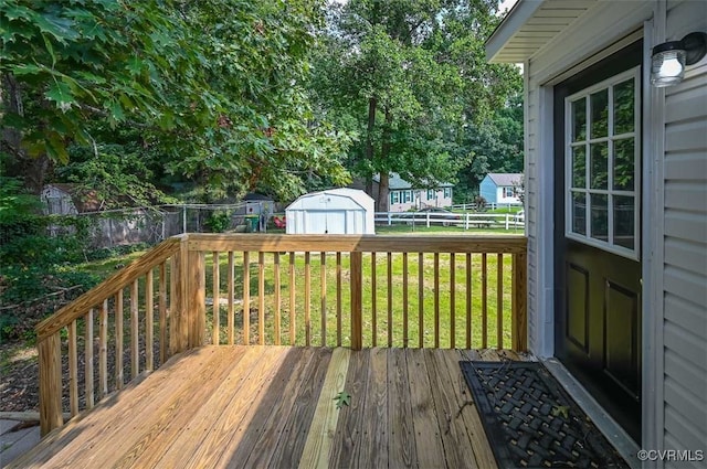 deck with a shed and a yard