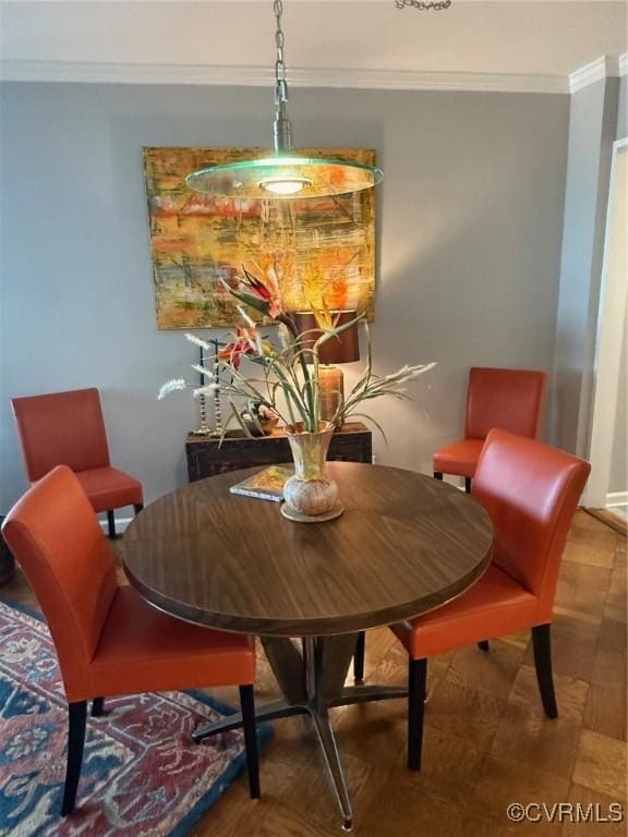 dining area featuring crown molding