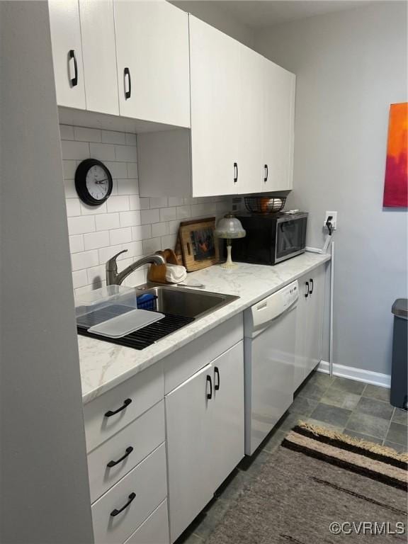 kitchen featuring dishwasher, decorative backsplash, white cabinets, and sink