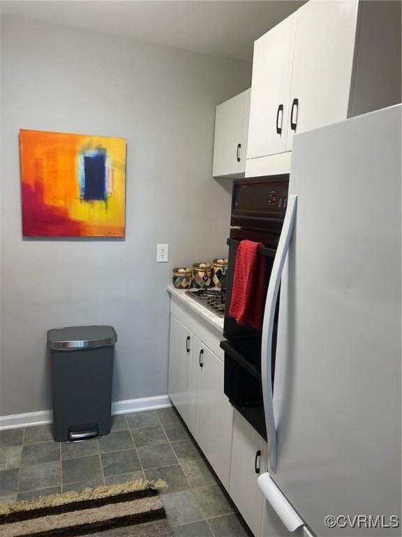 kitchen featuring white cabinets and black appliances