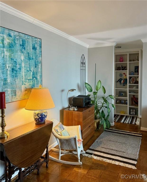 sitting room featuring built in shelves and ornamental molding