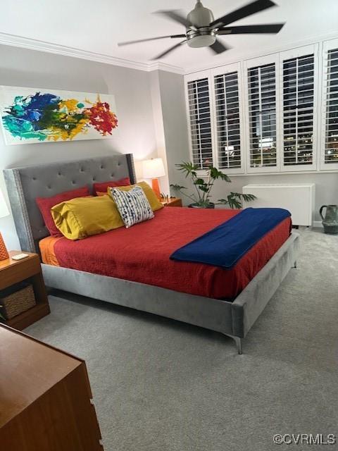 bedroom featuring carpet, ceiling fan, and ornamental molding