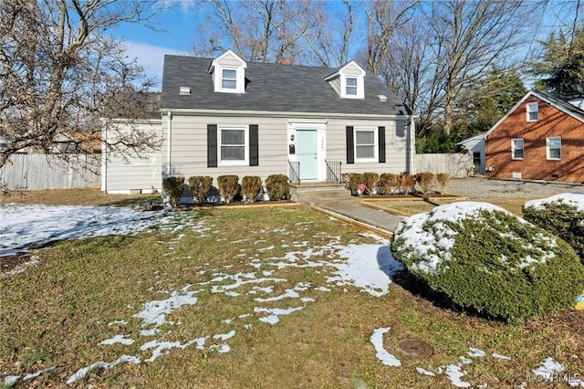 cape cod house with a lawn