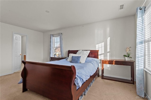 bedroom featuring light colored carpet