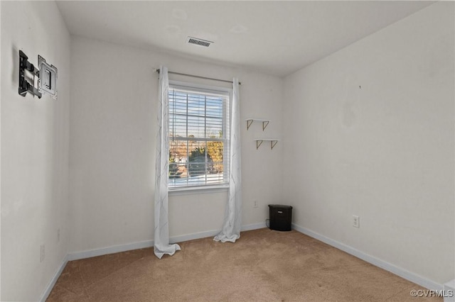 spare room with light colored carpet