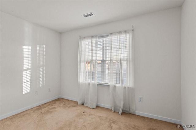 spare room with light colored carpet