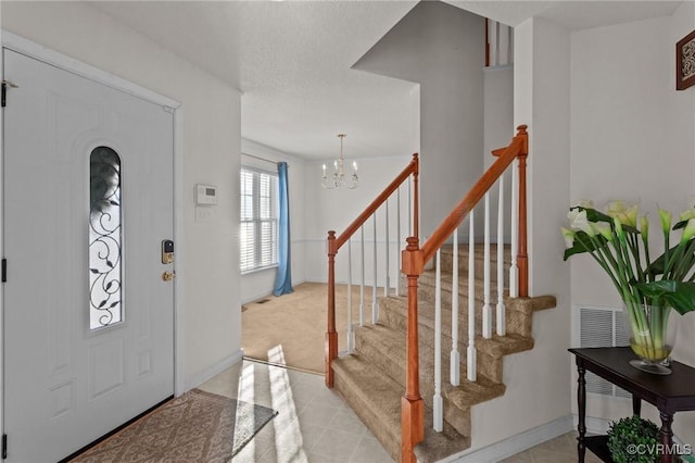 foyer with an inviting chandelier