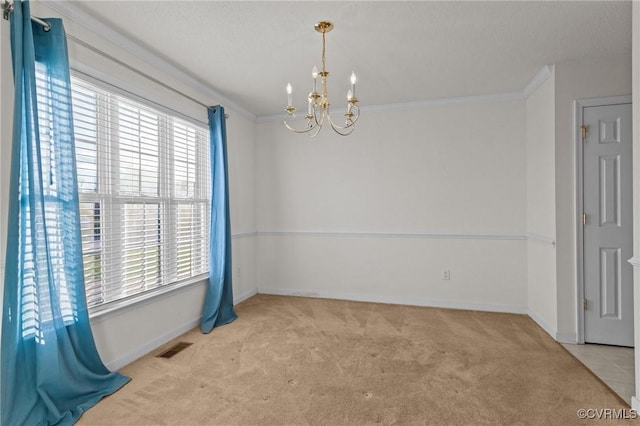 spare room featuring a notable chandelier, ornamental molding, and light carpet