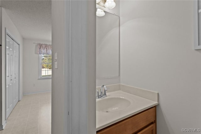 bathroom with vanity and a textured ceiling