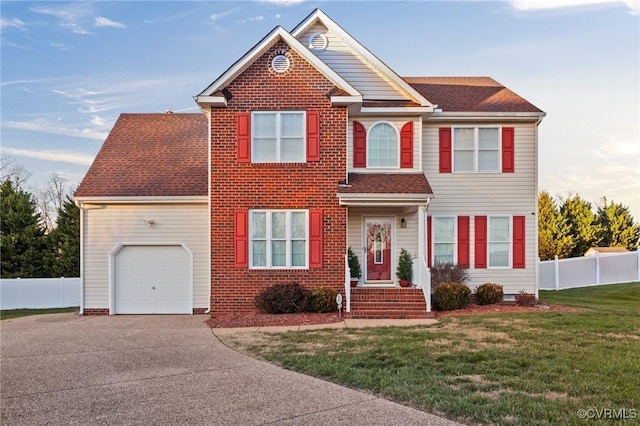 view of front of house with a garage and a front lawn