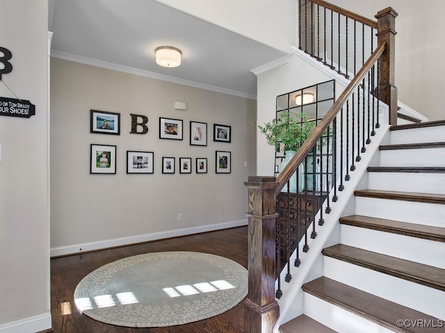 stairway with ornamental molding and hardwood / wood-style flooring