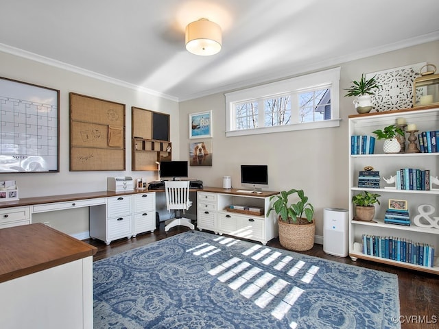 home office with built in desk, dark wood-type flooring, and ornamental molding