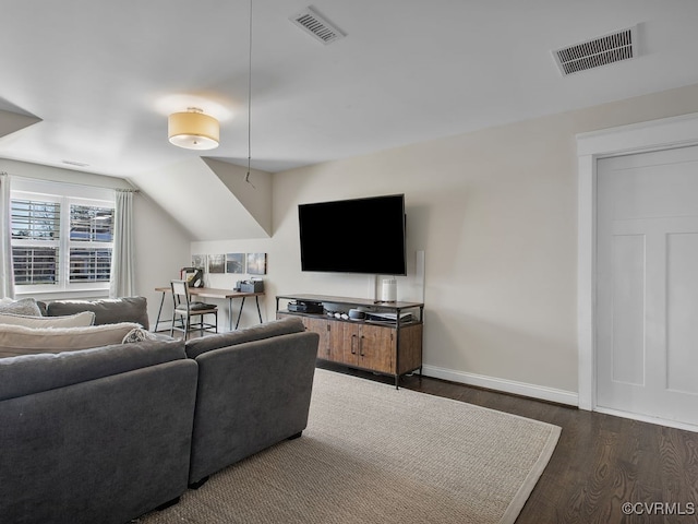 living room featuring dark wood-type flooring and vaulted ceiling