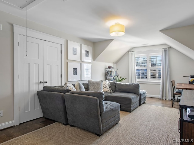 living room featuring hardwood / wood-style flooring and vaulted ceiling