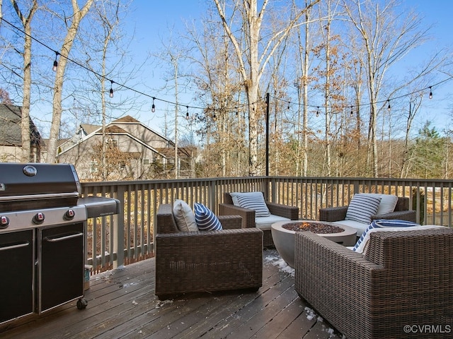 wooden deck with area for grilling and an outdoor fire pit