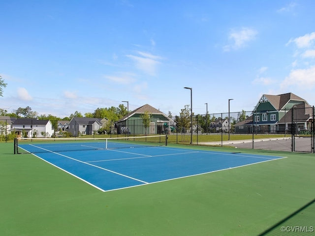 view of tennis court featuring basketball hoop