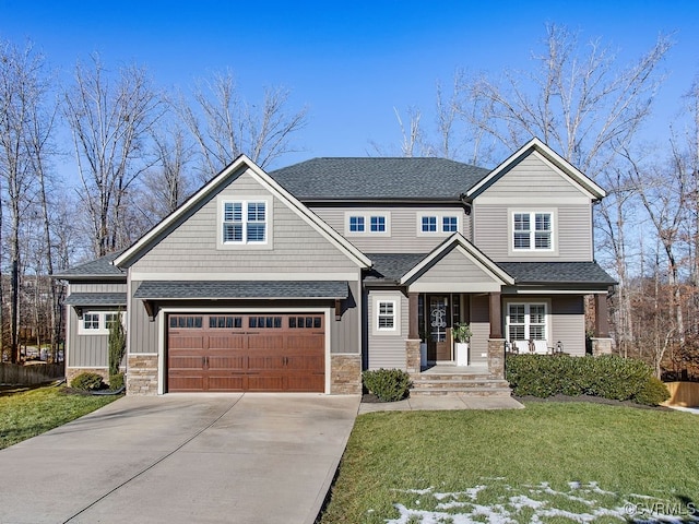 craftsman house with a front yard and a garage