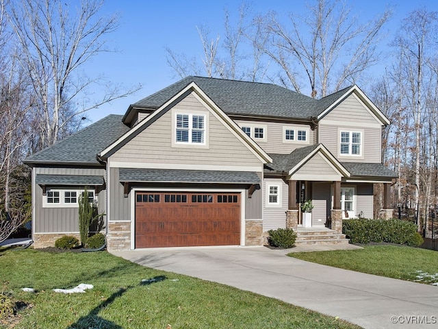 craftsman house featuring a front yard and a garage