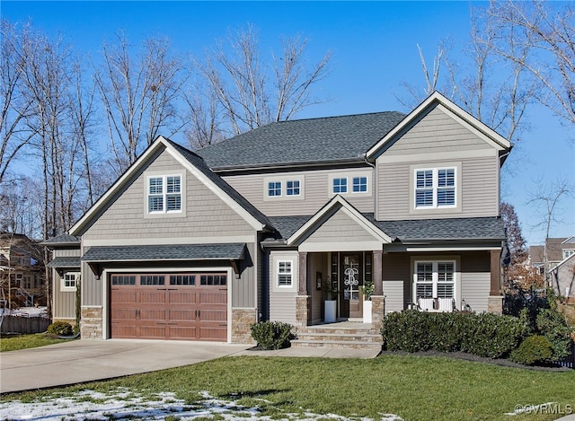 craftsman inspired home with a front yard and a garage