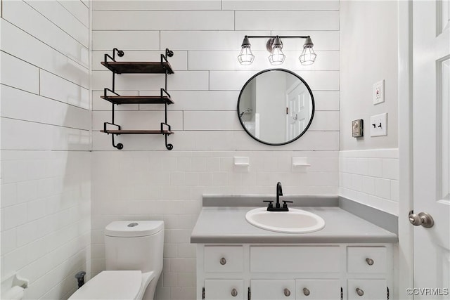 bathroom featuring toilet and vanity