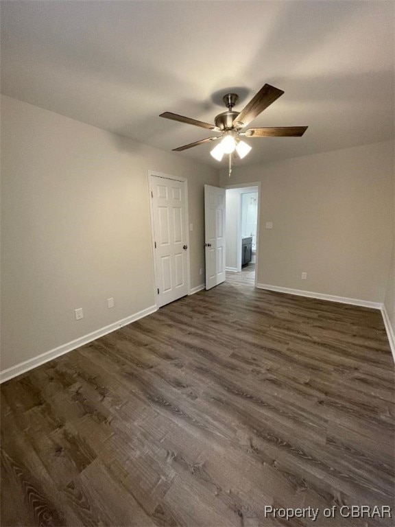 spare room with dark hardwood / wood-style floors and ceiling fan